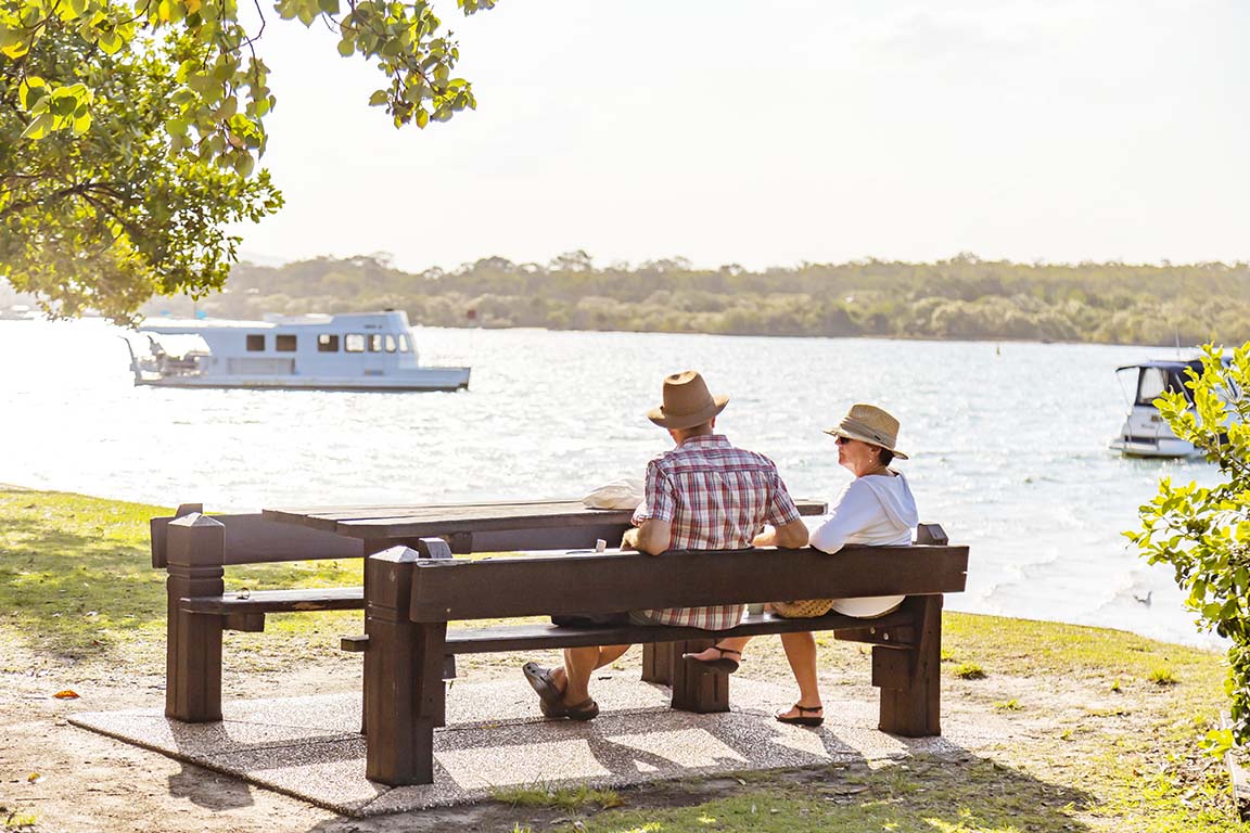 Things To Do In Noosaville Couple Sat On Bench By The Noosa River